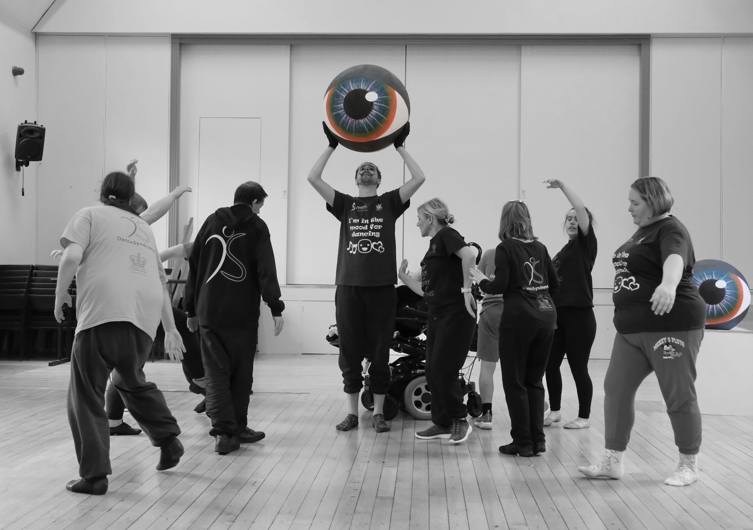 A photograph of the DanceSyndrome team rehearsing for the Edinburgh Fringe performances. They are dancing around a giant eye.