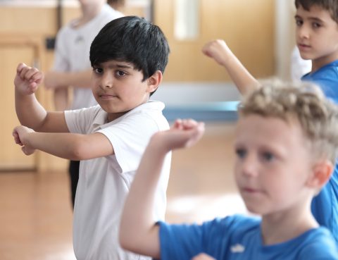 Children taking part in a DanceSyndrome inclusive dance session in a school setting.