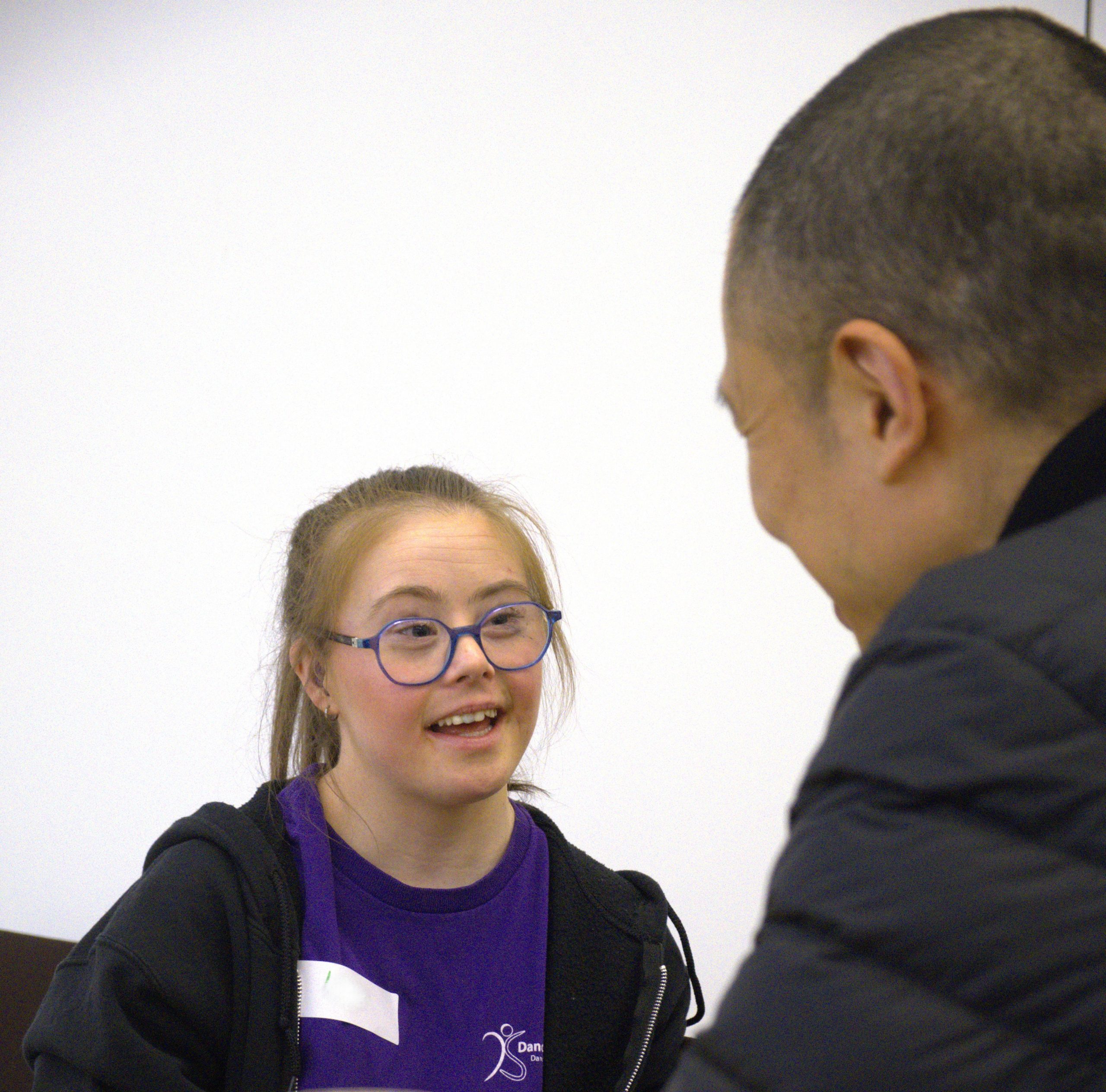 Kady Ward, a DanceSyndrome Artist with a learning disability is talking to Dai Matsuoka, an Artist from LandFes in Tokyo.
